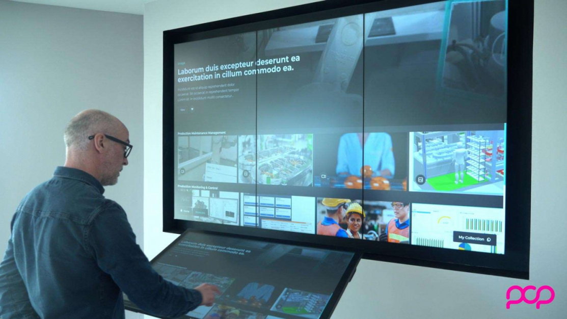 Interactive video wall displaying videos and engineering images which are controlled from a touchscreen with man standing in front